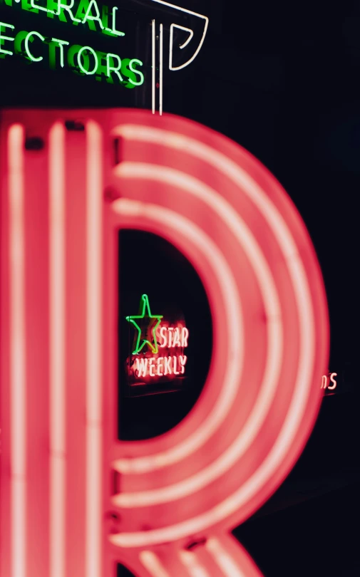 a neon red sign in front of a building