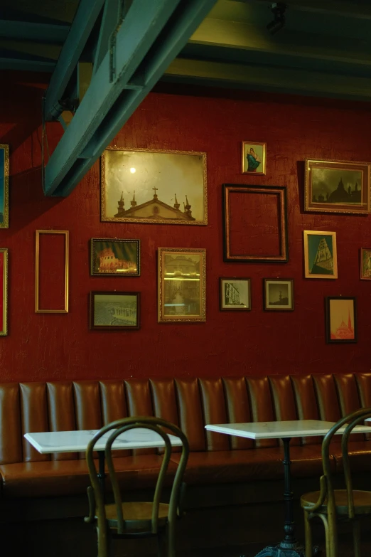 red walled area with various chairs and pictures on the walls