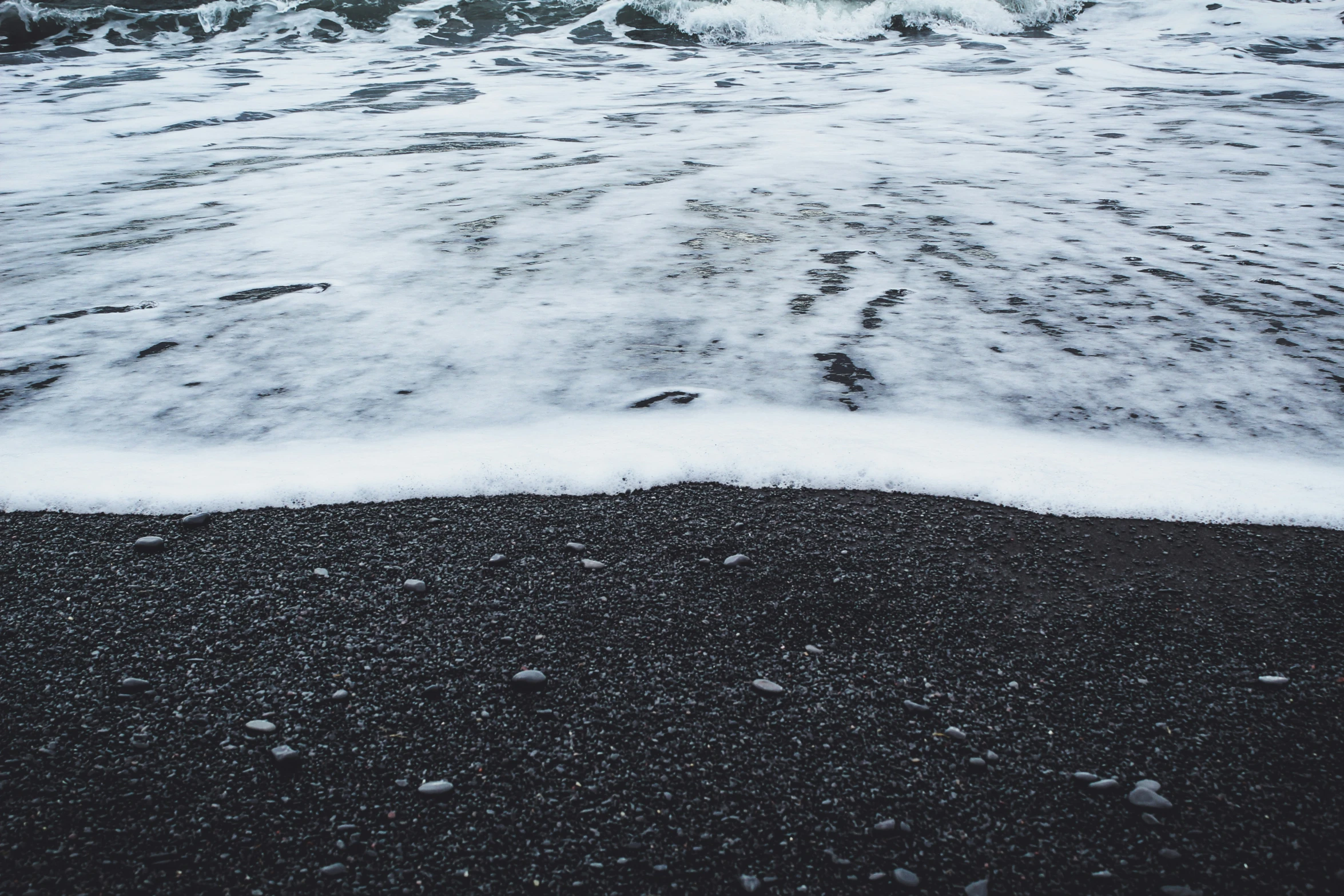 a wave coming in at the shore line