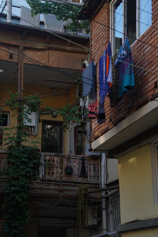 several laundry hanging out to dry outside of an apartment building