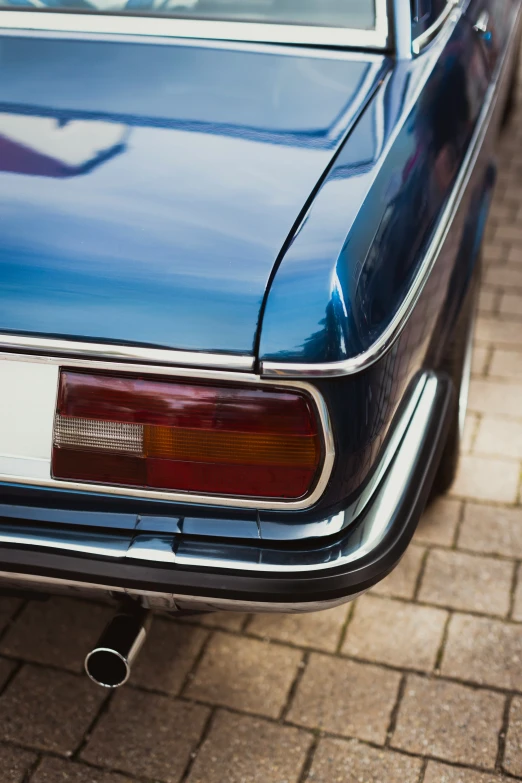 an old classic car is parked on the sidewalk