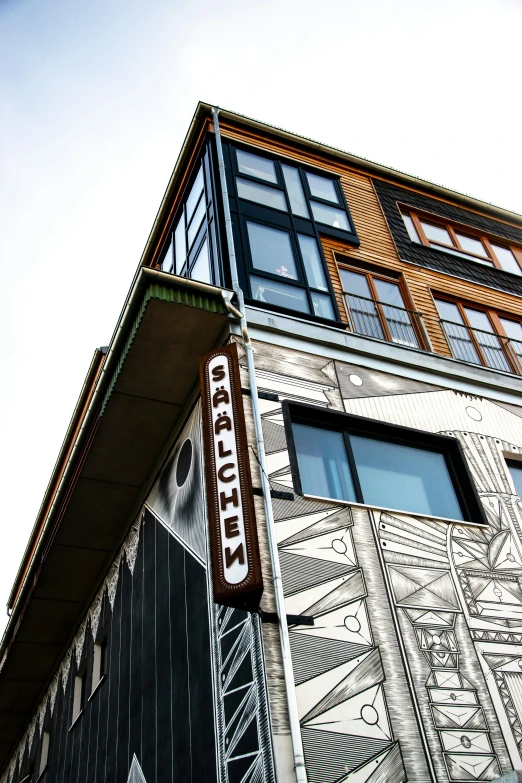 a large colorful building is shown with windows and a street sign