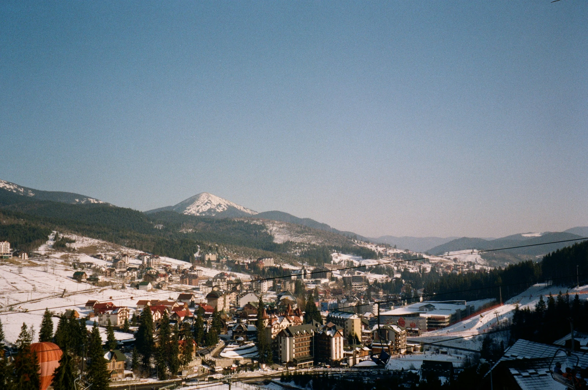 a view of the top of a mountain with buildings in it