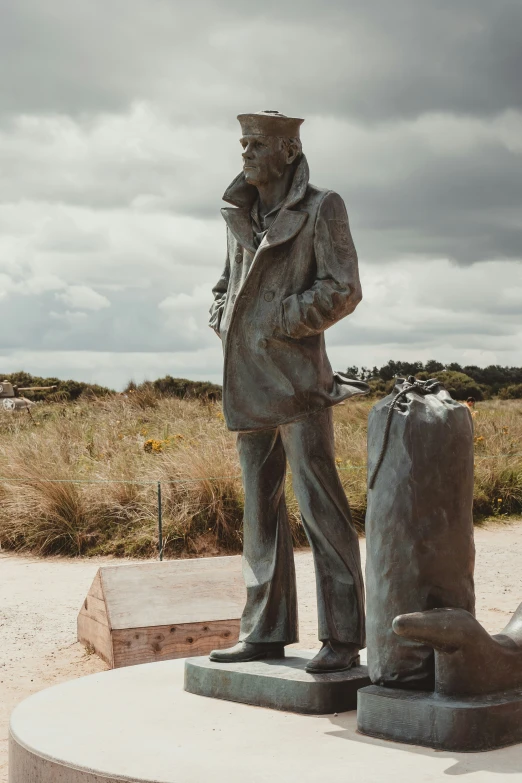 a statue of a man holding an old crate in front of him