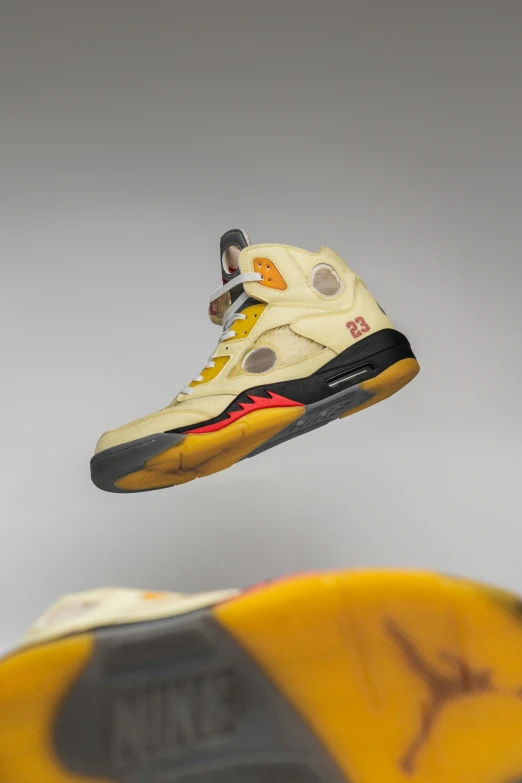 the shoe is yellow and has black upper soles