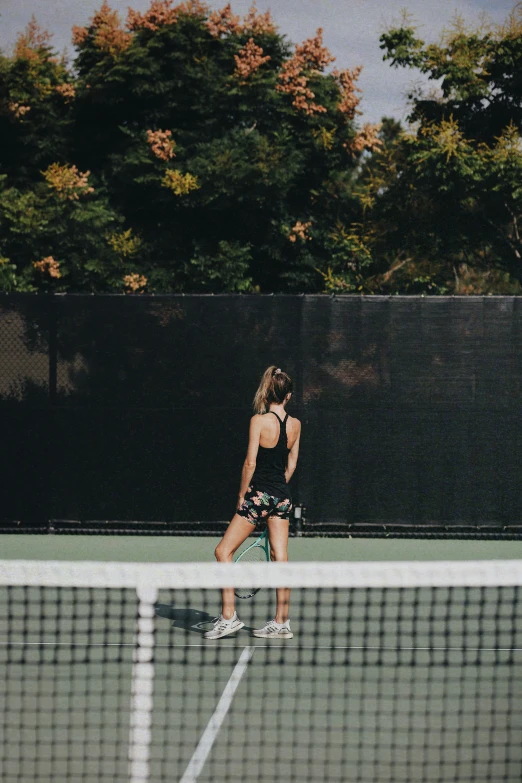 a  is playing tennis and looking at the net