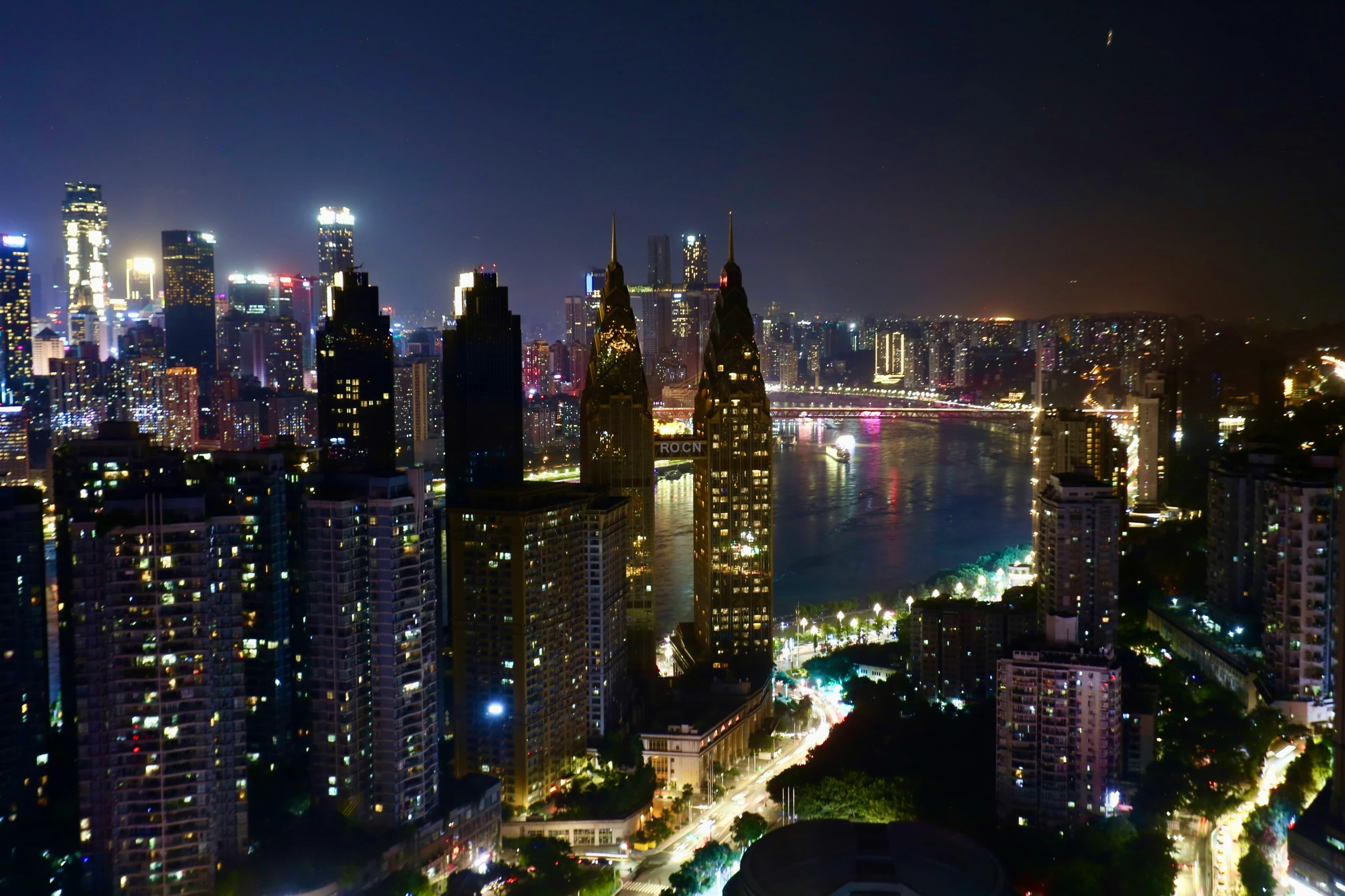 a city skyline at night with lights and street below