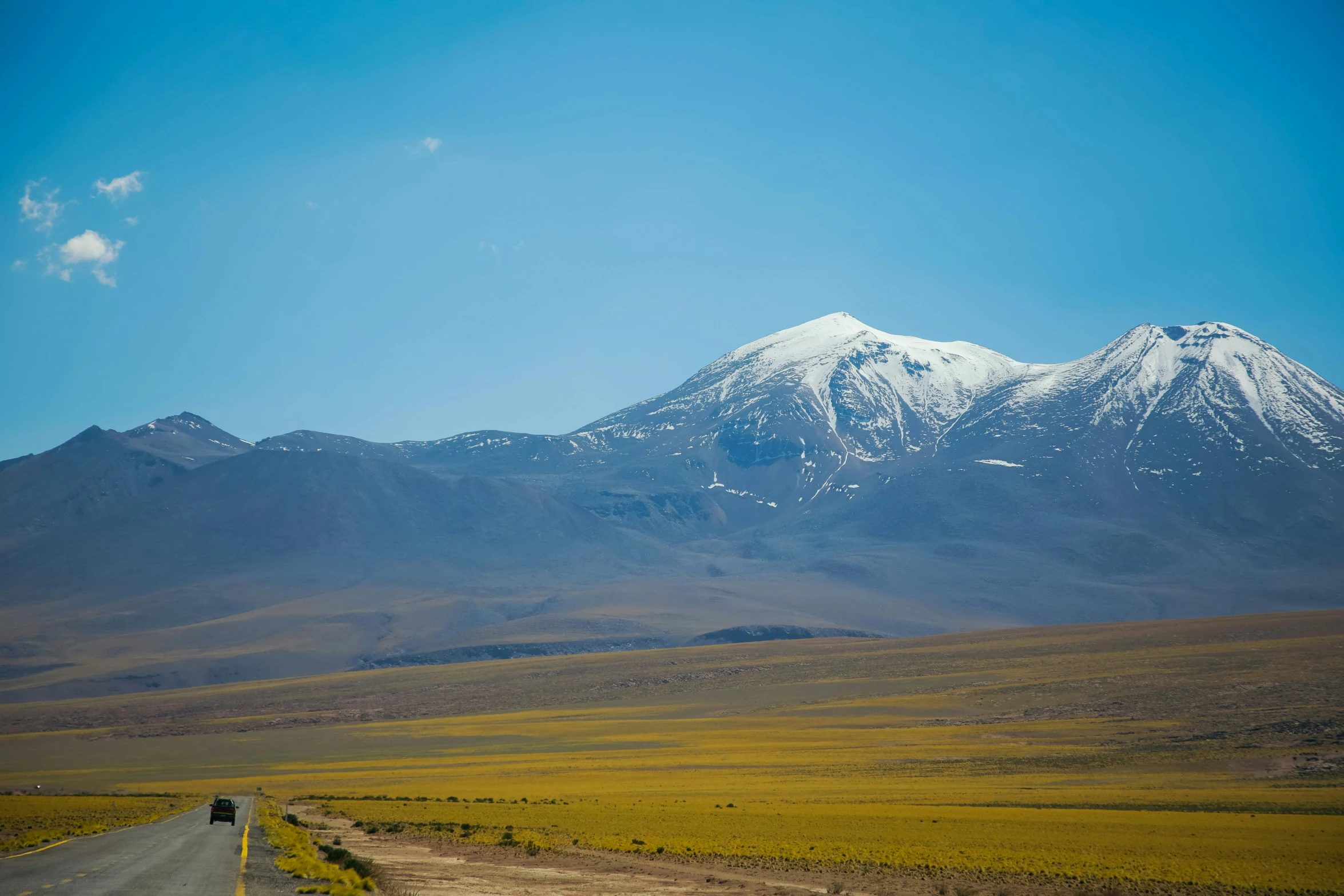 there is a road and mountain in the distance