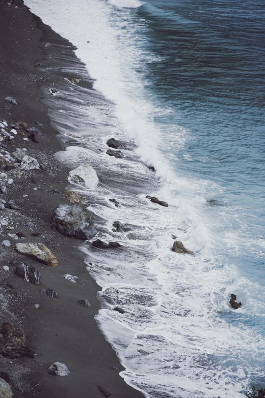 the ocean is very calm but rocky beach