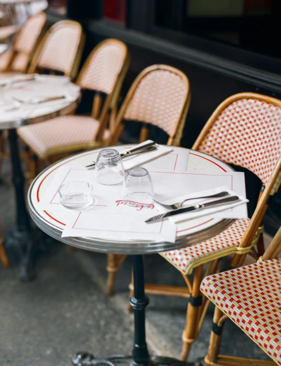 chairs and tables with matching tablecloths are set out for an event