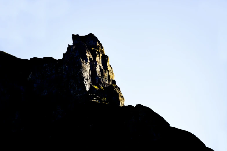 the top of a rocky mountain with a bright blue sky