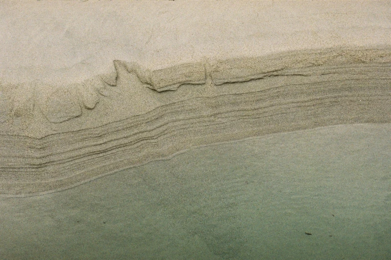 sand that has been made into a wave and is in the water