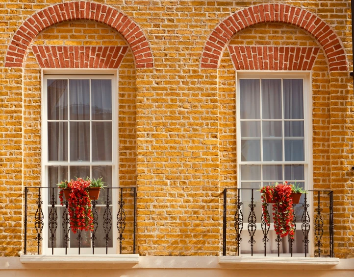 two large brick windows with bowed planters