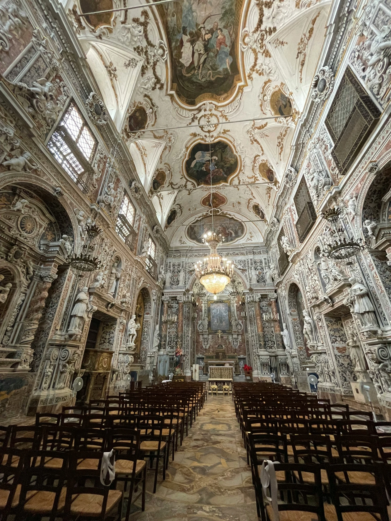 an empty church that has stained glass in the ceiling