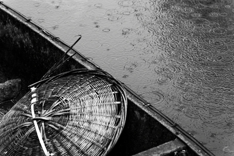 an umbrella lies in a boat filled with water