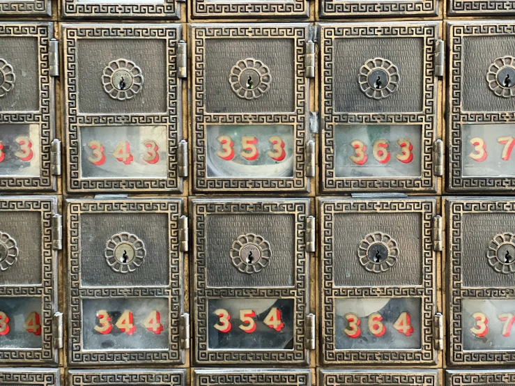 many different mail boxes that have numbers on them
