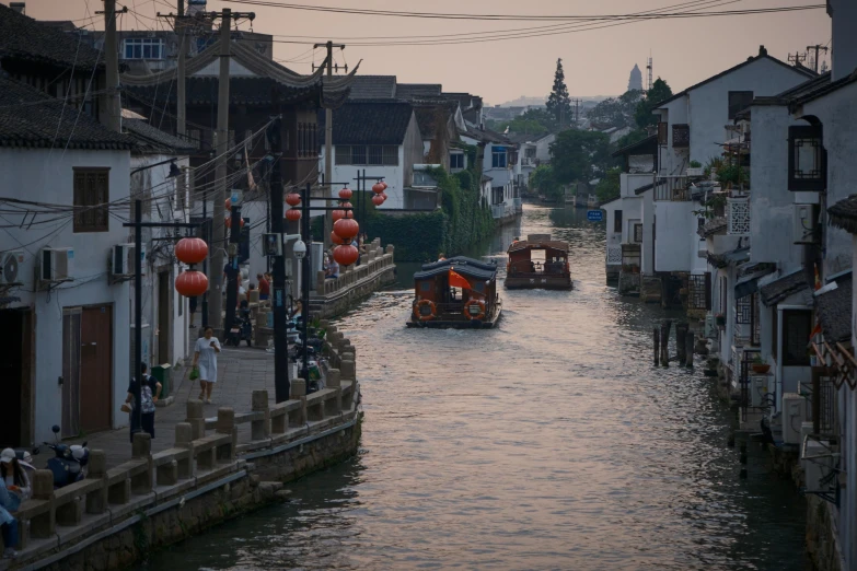 an image of a narrow canal running through a city