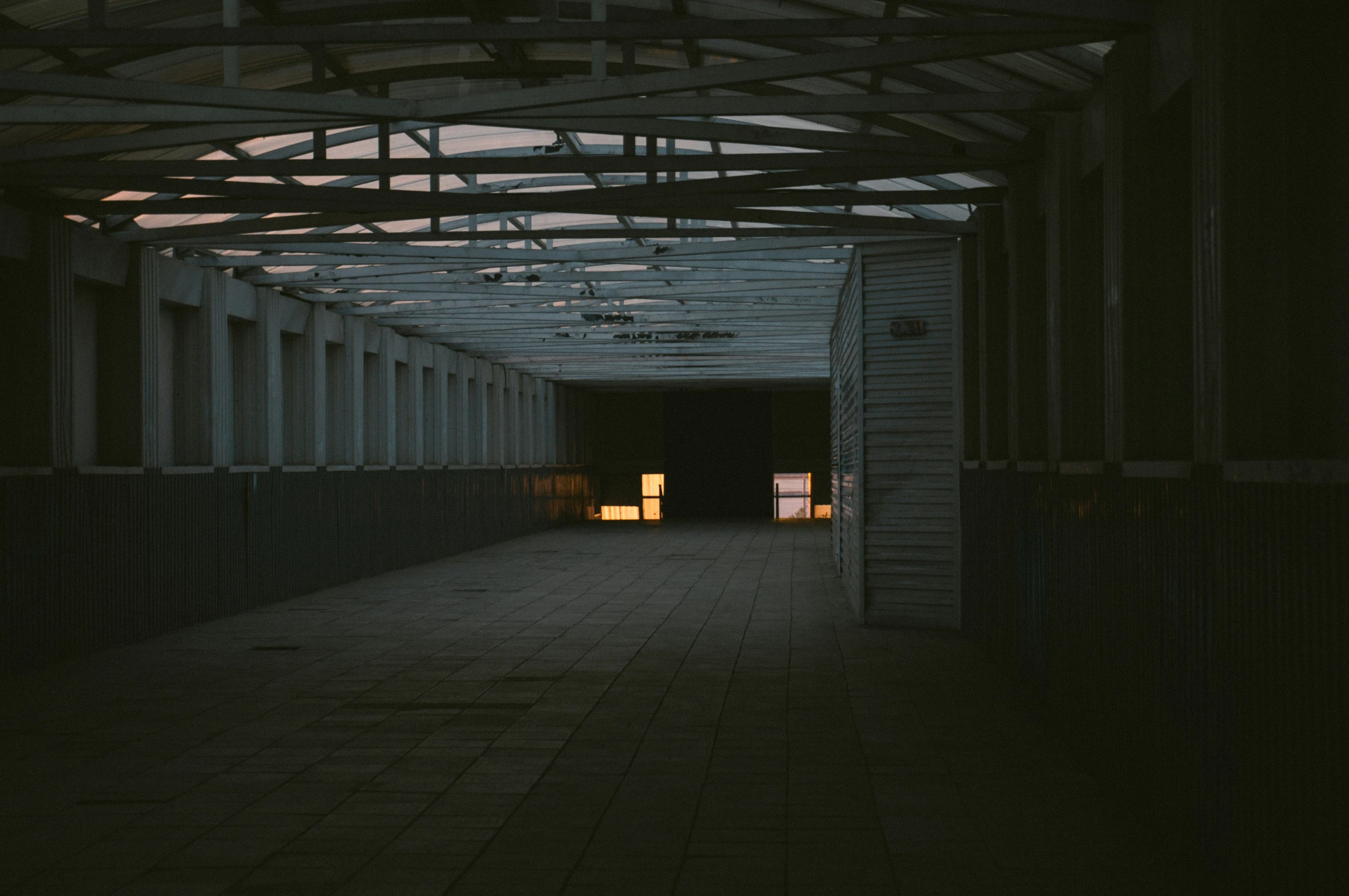 inside a parking garage that has an exit to another space