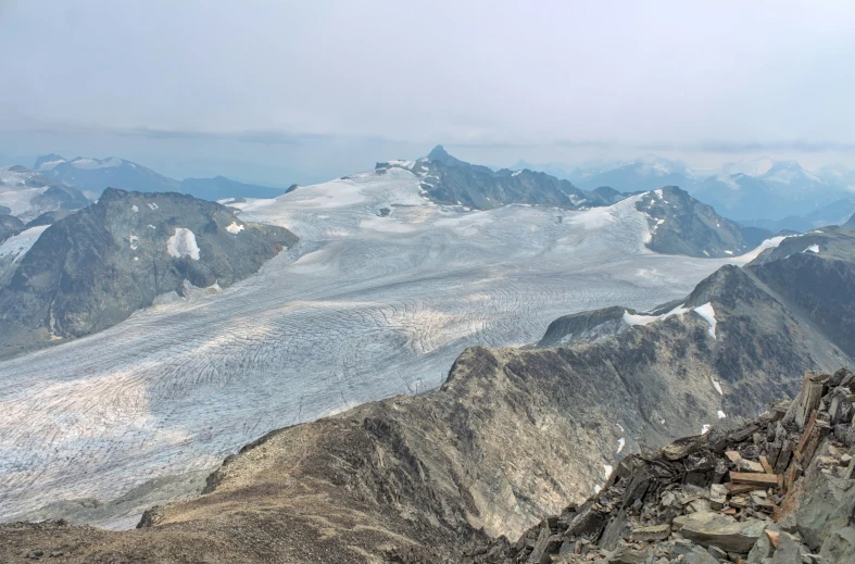 a person standing on top of a mountain with snow