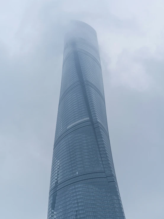 a very tall building with a lot of fog around it