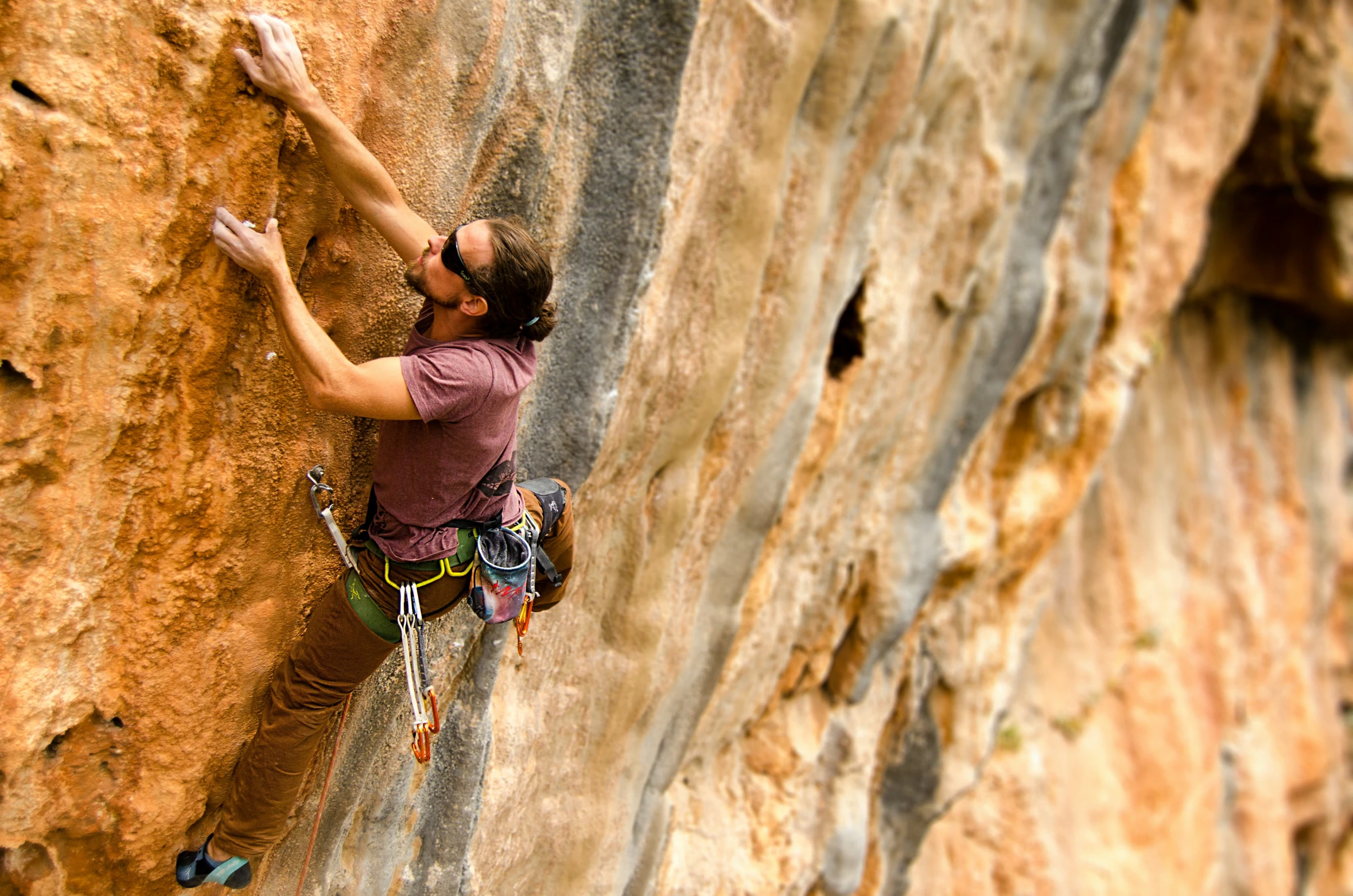 a man climbing down the side of a large cliff