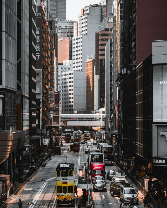 a bus is driving down a busy street with tall buildings