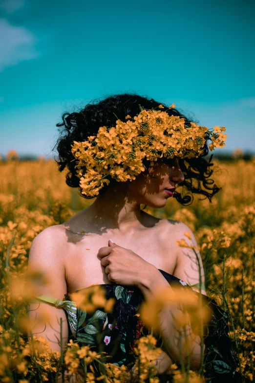 a girl is standing in a field with flowers