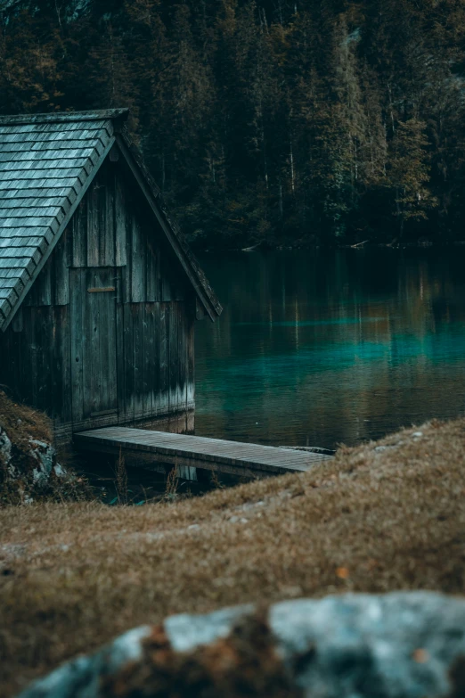 a shed sitting near a body of water