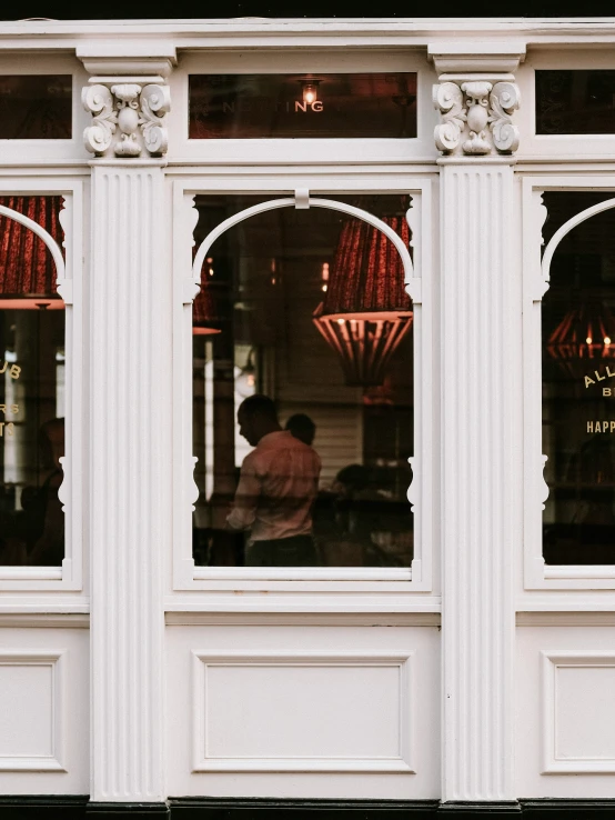 a restaurant with people looking out of the windows