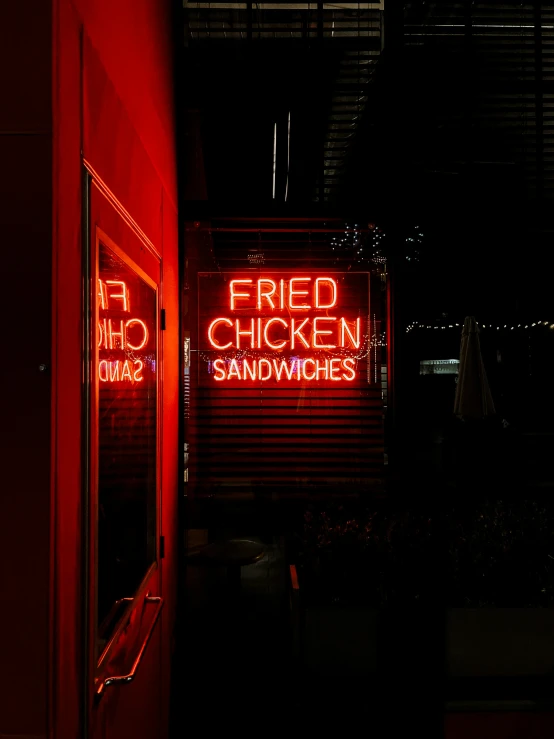 a neon sign and the reflection of a window