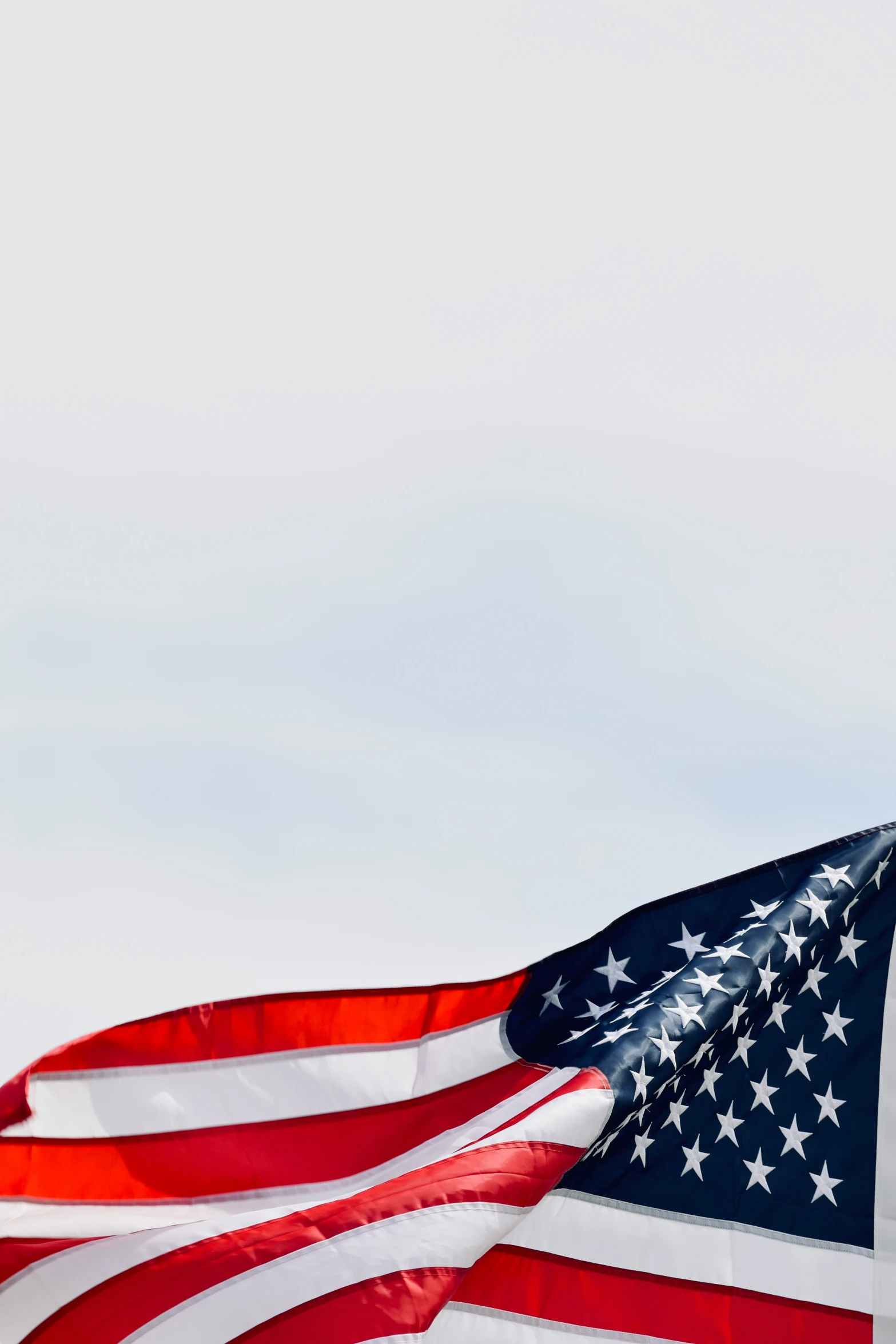 a large american flag blowing in the wind