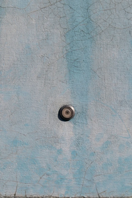 an object floating in the middle of a cement wall