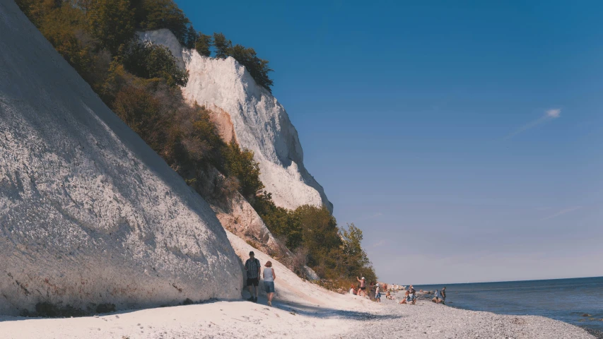 some people walking up the side of a rock wall