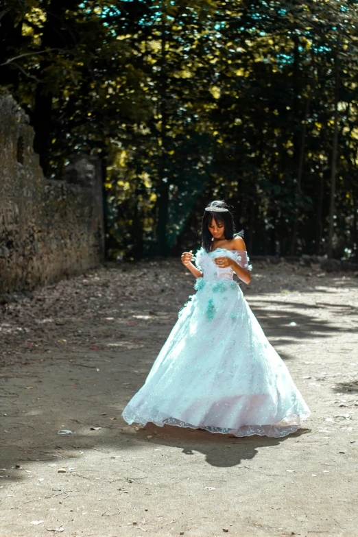 a girl in a dress walking down the street