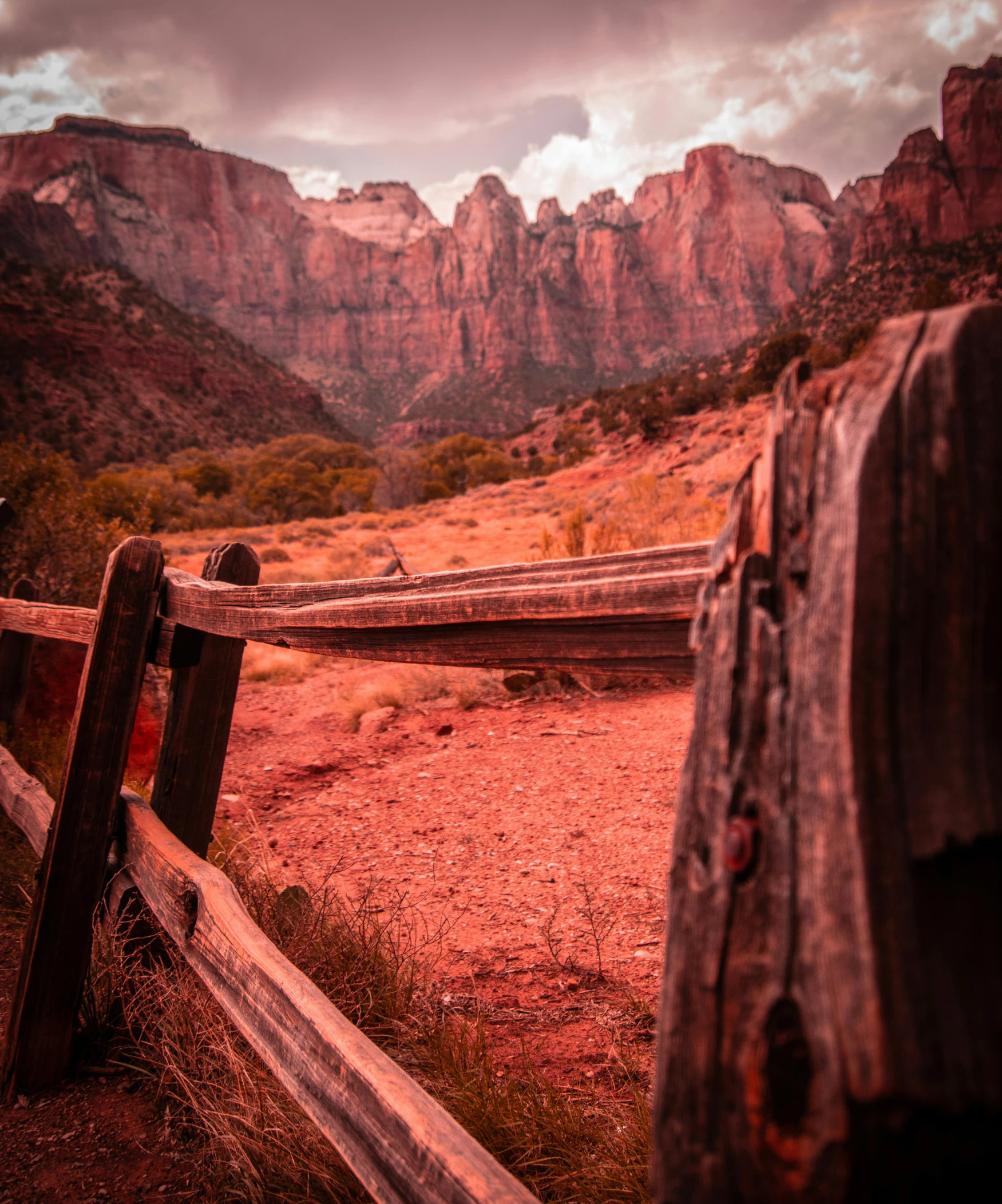 some wooden fences and mountains are in the background