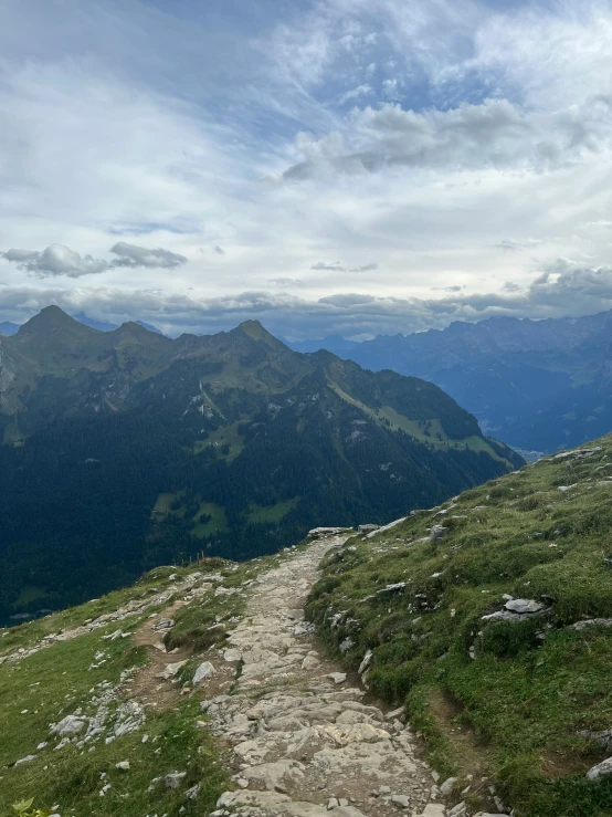 a trail going up a mountain side in the mountains