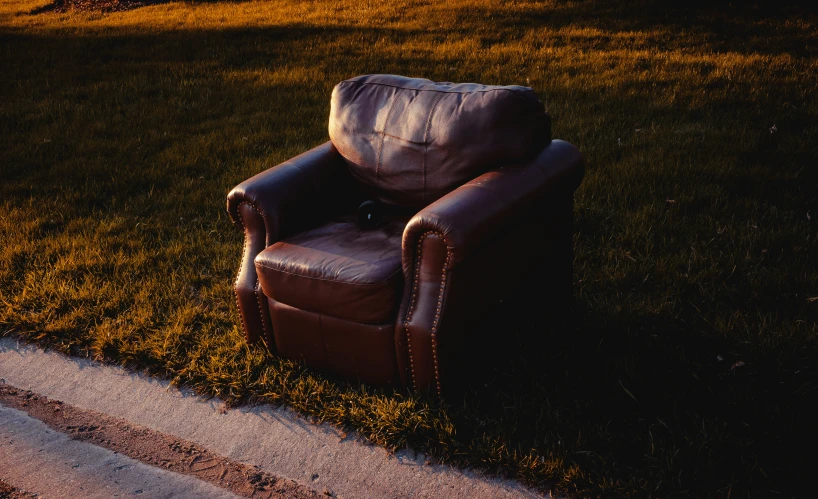 chair on lawn near walkway during daytime