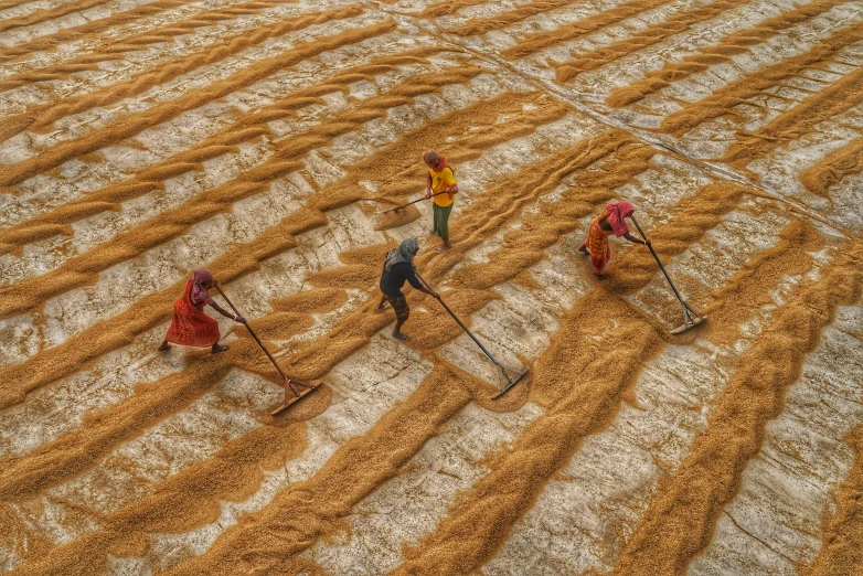 three people who are in the middle of a field