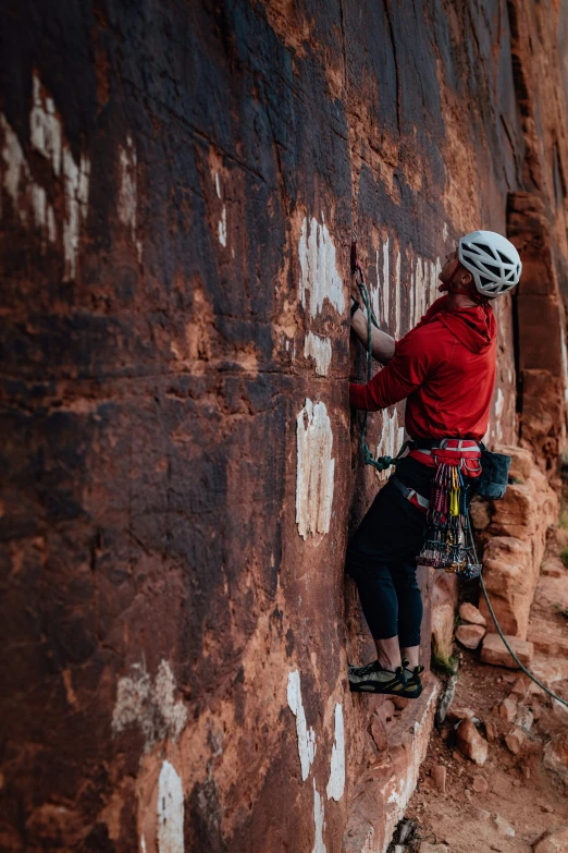 a person climbing up the side of a cliff