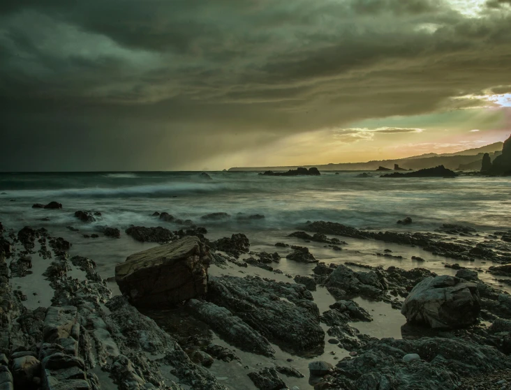 the sky and water are covered in a very dark cloud