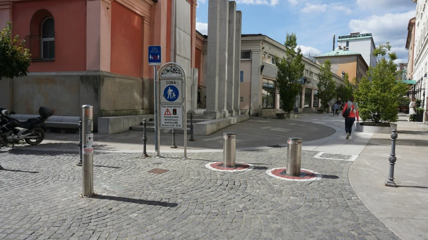 a town street with stone pavers and road dividers