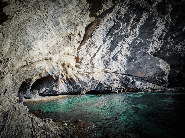 the inside of a cave on a beach