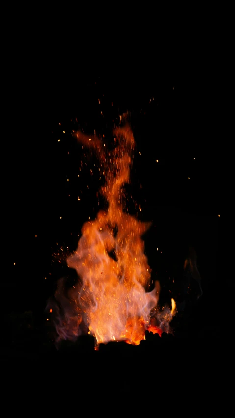 a large bright fire is lit up in the dark