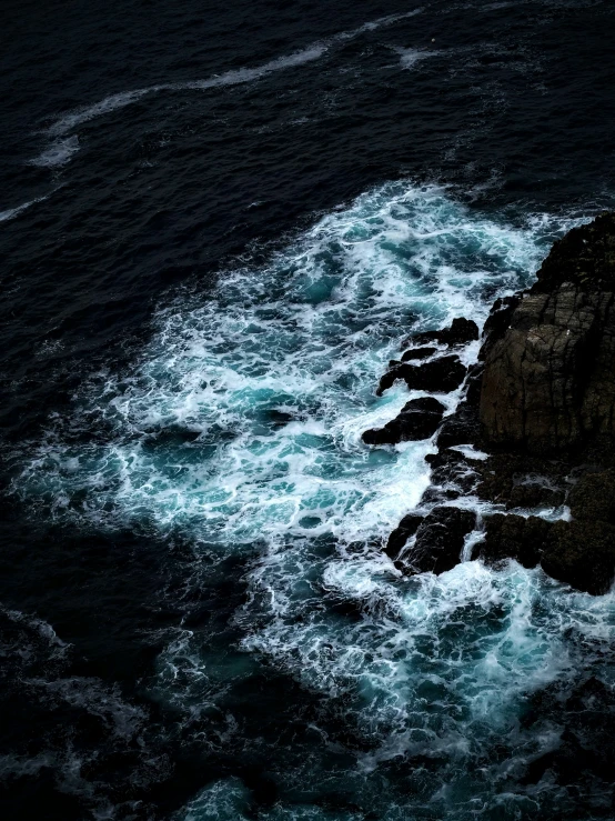 a body of water with a cliff next to it