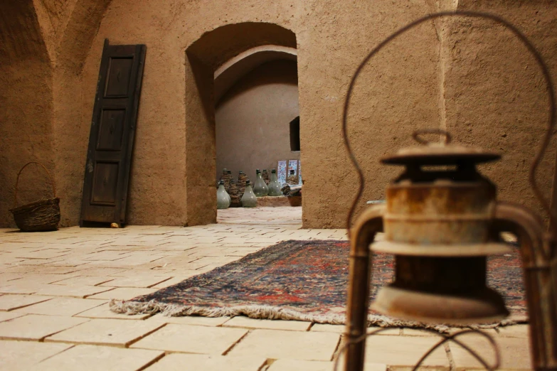 a hallway with a large oriental rug and vases in it