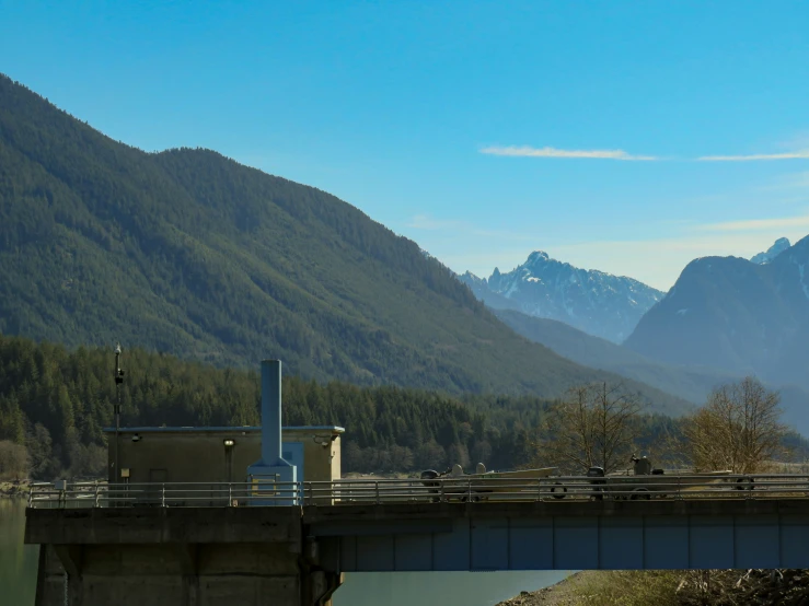 some tall mountains that are next to a bridge