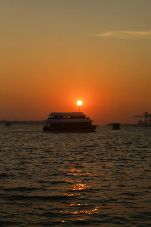 boats pass at the sunset on a large body of water