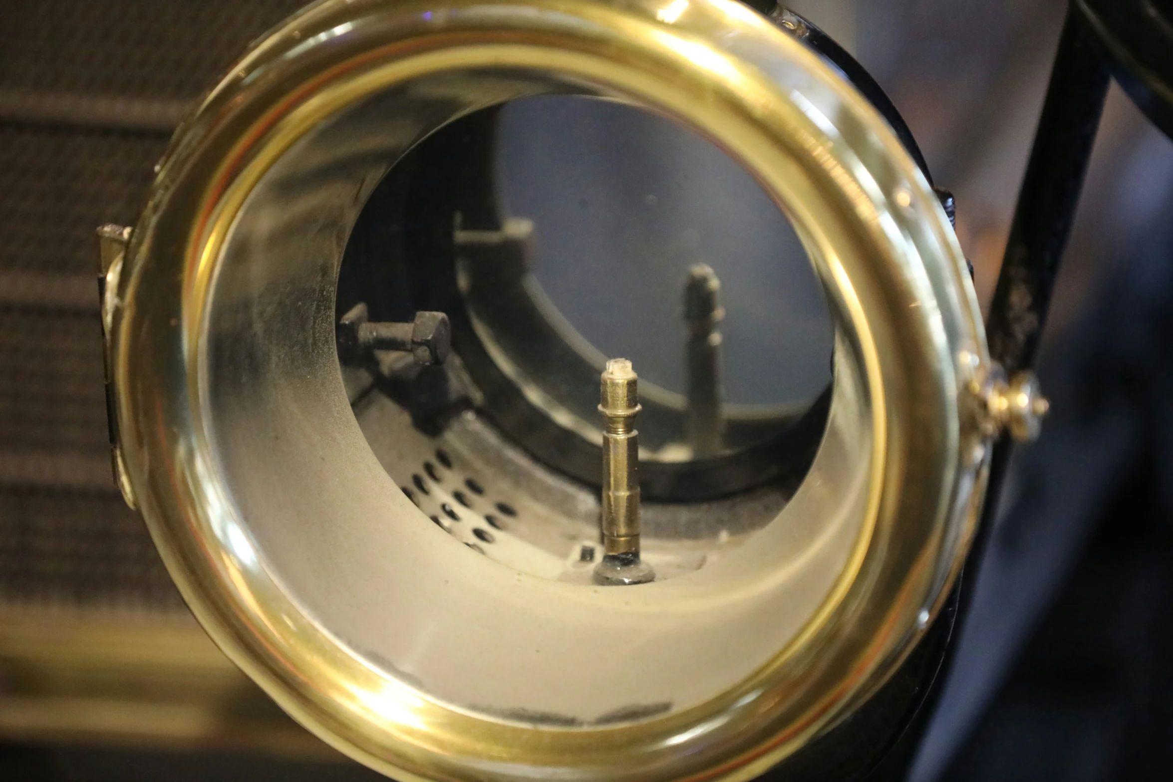 a large round mirror with a metal object sticking out of it