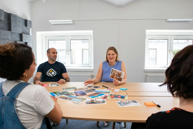 two people sitting at a table with a couple of posters