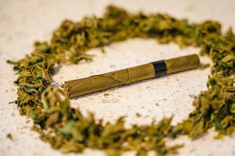 a stick of grass is arranged into a circle on the table